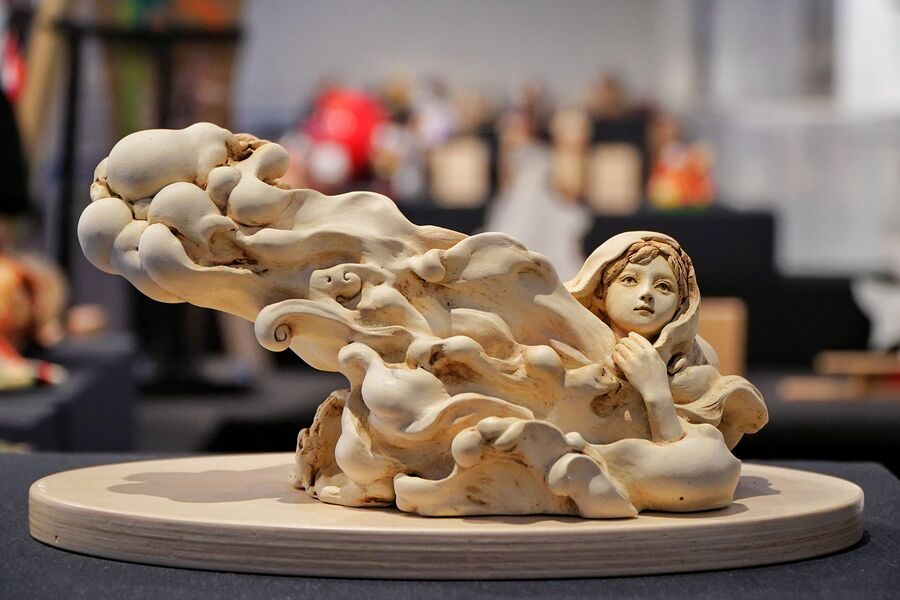 This work is named ‘Let the pure rain fall’ and is by an artist named Igeta Hiroko. The doll is made with baked clay and depicts the wish to become like a cloud that will pour rain on the land