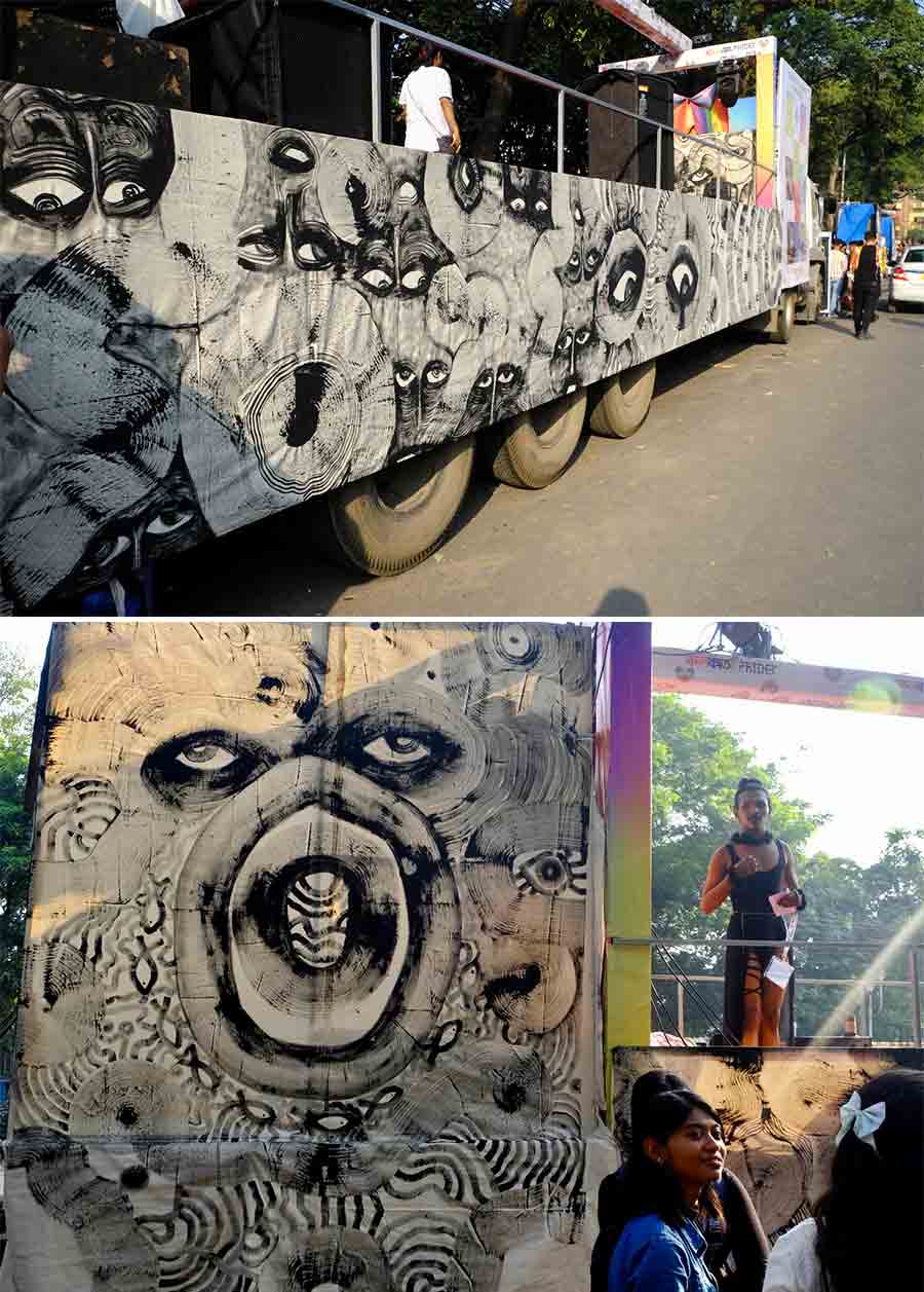 In a unique break from tradition, this year’s float had a 300-inch monochrome acrylic paint artwork by artist Archee Roy, titled ‘I, Exist’. Talking to My Kolkata about her piece, Archee said, ‘It captures the intersectional politics of queer-trans identity amidst India’s present socio-political climate. At its heart are eyes that reflect, reveal and hold truths silently, yet with unrelenting intensity. It is a visual assertion of our lives, and a declaration that despite marginalisation, we persist’