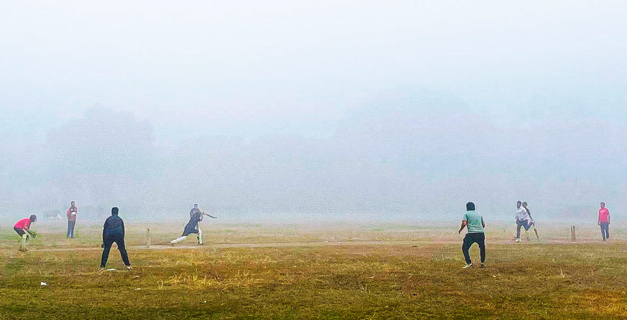 Youngsters brace winter fog to enjoy a game of cricket at the Maidan on Tuesday morning