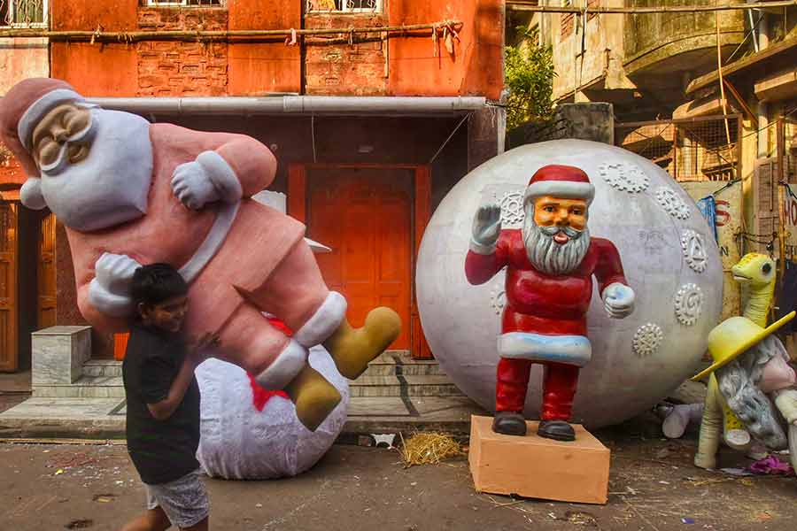 A boy carries a mannequin of Santa Claus from Dompara on Wednesday