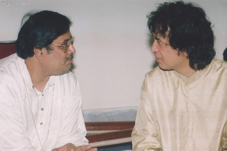 Pandit Ajoy Chakrabarty with Zakir Hussain on the sidelines of a programme in Kolkata many years ago