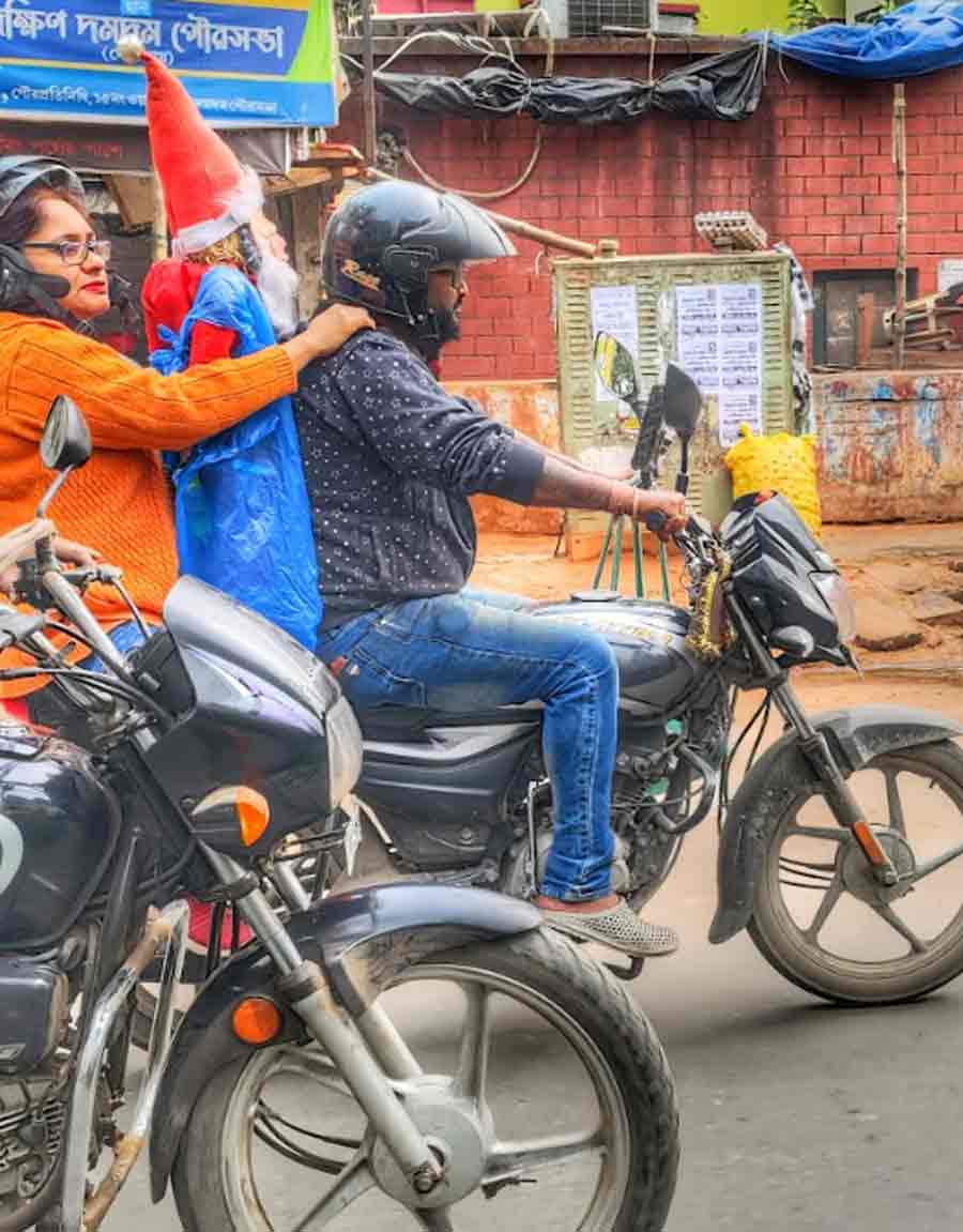 Santa rides pillion on a bike on Friday