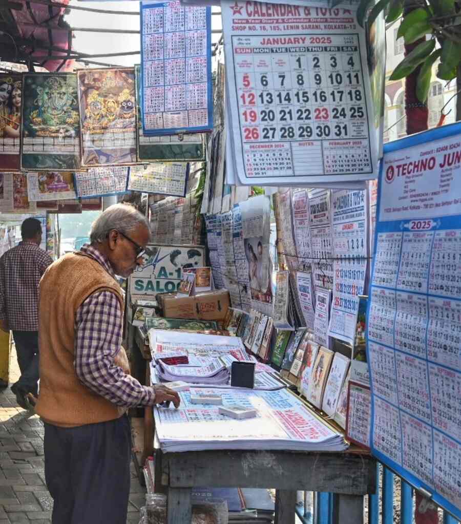 As the year ends, people buy calendars for 2025 at Esplanade on Monday