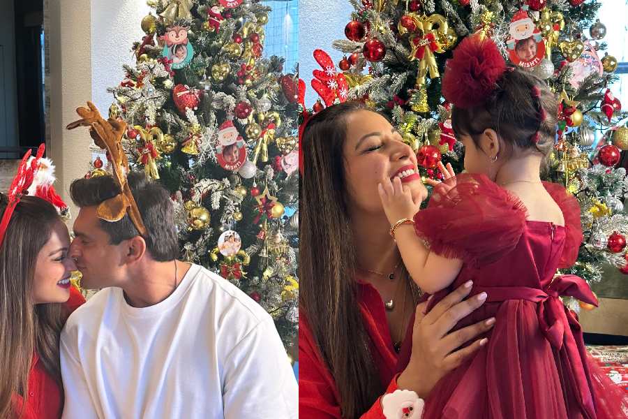 Karan Singh Grover kissed wife Bipasha Basu, who donned a red shirt and reindeer horns. Bipasha embraced their two-year-old daughter Devi, who looked adorable in a flowy red frock. 