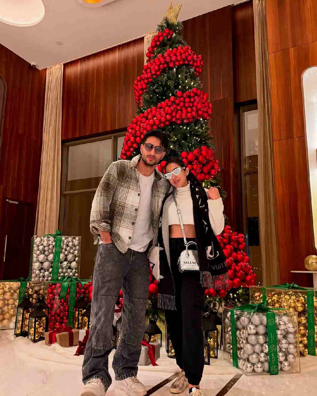 Siblings Sara Ali Khan and Ibrahim Ali Khan posed in front of a Christmas tree in monochrome outfits. 