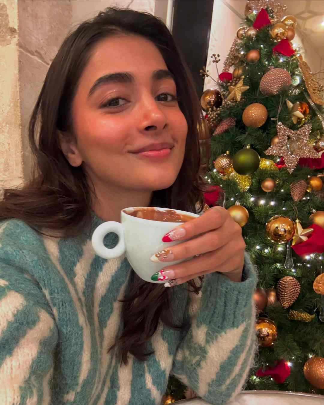Dressed in a blue-and-white sweater Pooja Hegde enjoyed a cup of hot chocolate on Christmas. The actress has Rosshan Andrews’ Deva in the pipeline.  