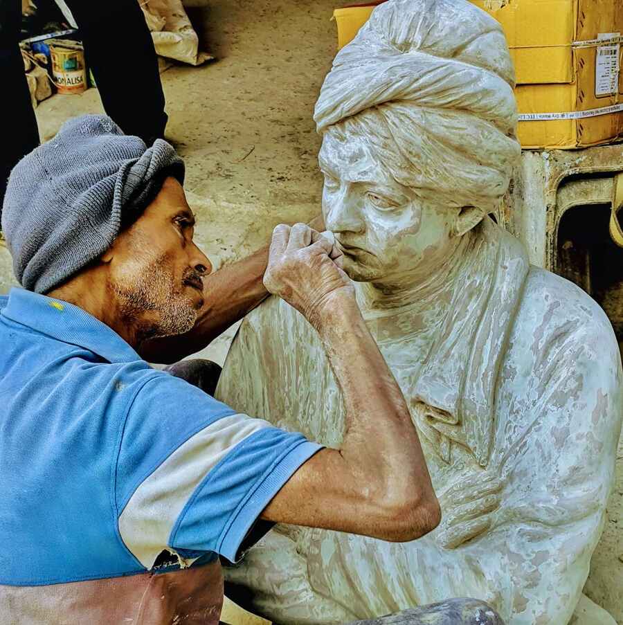 An artist working on a fibreglass statue of Swami Vivekananda ahead of his birth anniversary on January 12  