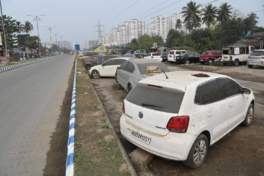 Cars parked in a service lane in New Town on Wednesday. These vehicles used to be in garages that have been removed.