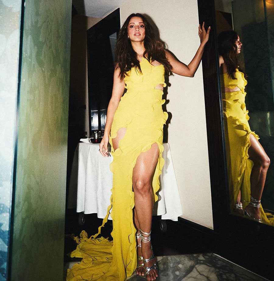 Triptii Dimri, who’s recently been in the spotlight for her romantic turn with Ranbir Kapoor in Sandeep Reddy Vanga’s Animal, looks stunning in a yellow cut-out dress with a thigh-high slit. This is a perfect choice for Valentine’s Day, which is on the same day as Saraswati Puja this year.