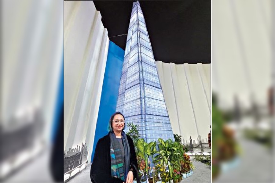 Structural engineer Roma Agrawal stands in front of the miniature replica of The Shard outside the Great Britain stall at the Book Fair