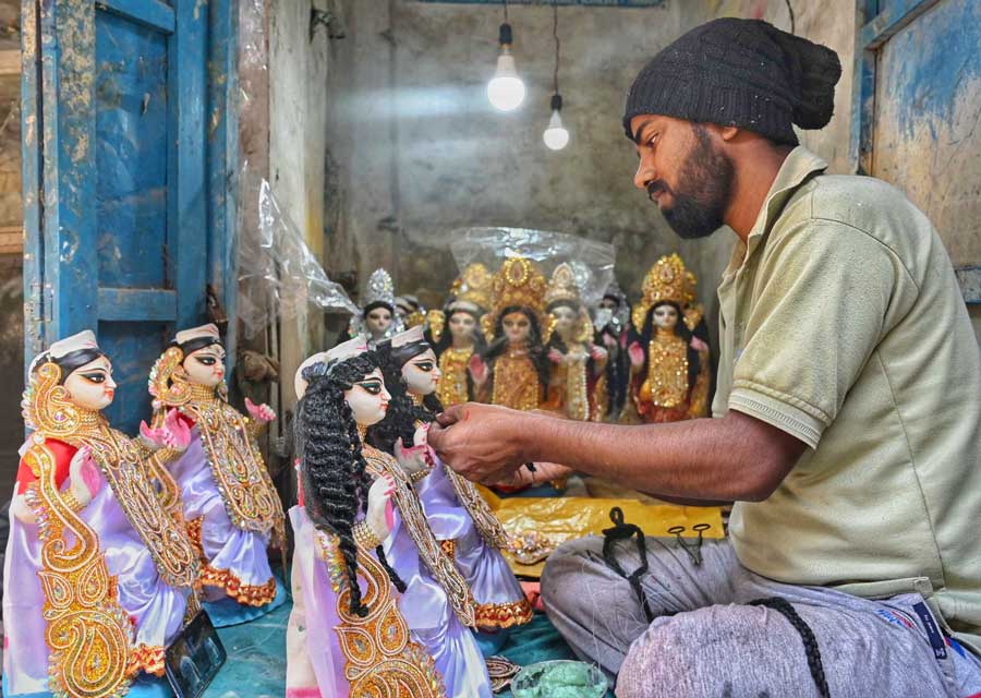 An artisan works on Saraswati idol at Kumartuli on Monday ahead of Saraswati Puja that falls on February 14  