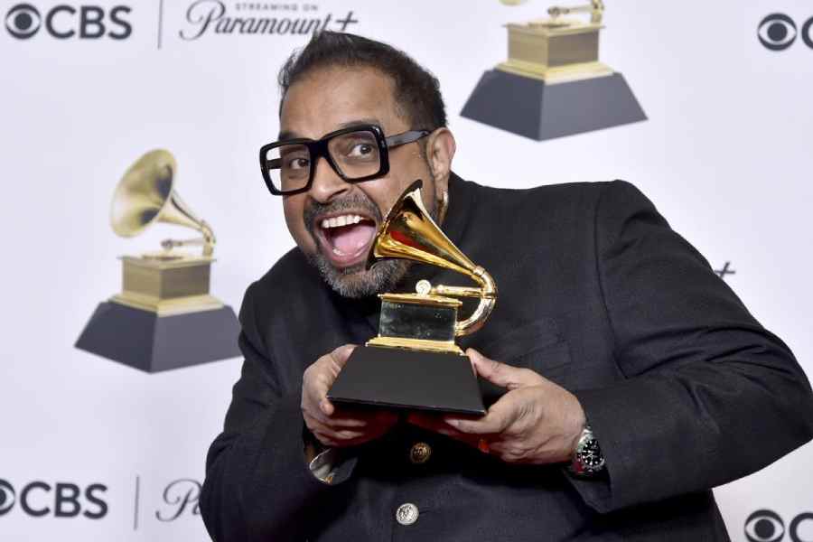 Shankar Mahadevan of Shakti poses in the press room with the award for best global music album for "This Moment" during the 66th annual Grammy Awards on Sunday.