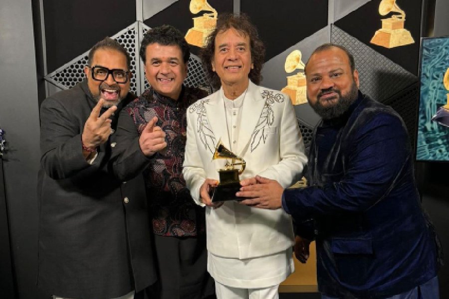 Ustad Zakir Hussain, vocalist Shankar Mahadevan, percussionist V Selvaganesh and violinist Ganesh Rajagopalan of Shakti pose for photos with the award for best global music album for 'This Moment' during the 66th annual Grammy Awards, in Los Angeles, USA, Sunday, Feb. 4, 2024.
