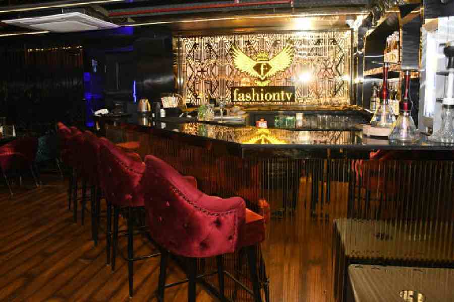 F Bar &amp; Cafe is all about black and gold interiors with plush furniture and wooden flooring. The bar boasts of the golden logo of FTV, making it an eye-catching corner on the mezzanine floor.
