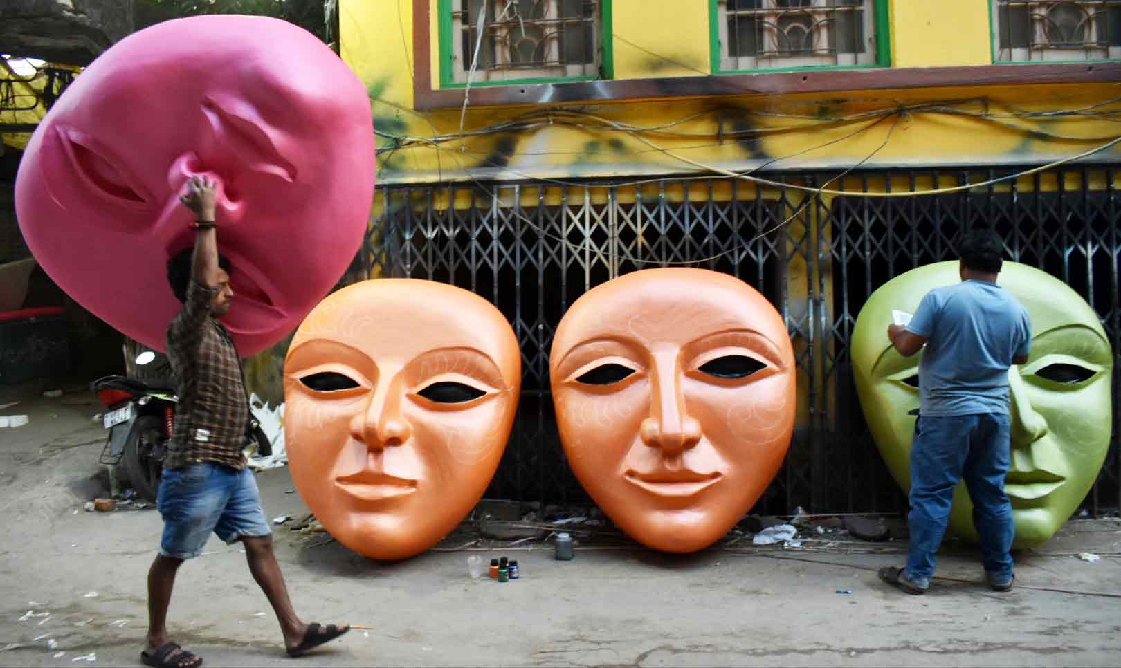 Artists of Dompara busy making larger-than-life human faces out of thermocol on Saturday for the wedding season 
