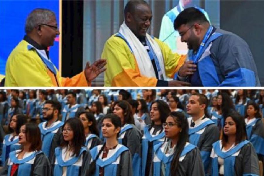 Kandeh Kolleh Yumkella, former under-secretary-general and special representative of the UN secretary-general for Sustainable Energy for All, hands over a medal to a graduate at the convocation of St Xavier’s University on Saturday; (right) students at the convocation