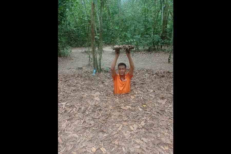 The guide demonstrating how to get inside one of the Cu Chi tunnels, which was one of the places where the locals hid during the two-decade-long Vietnam War