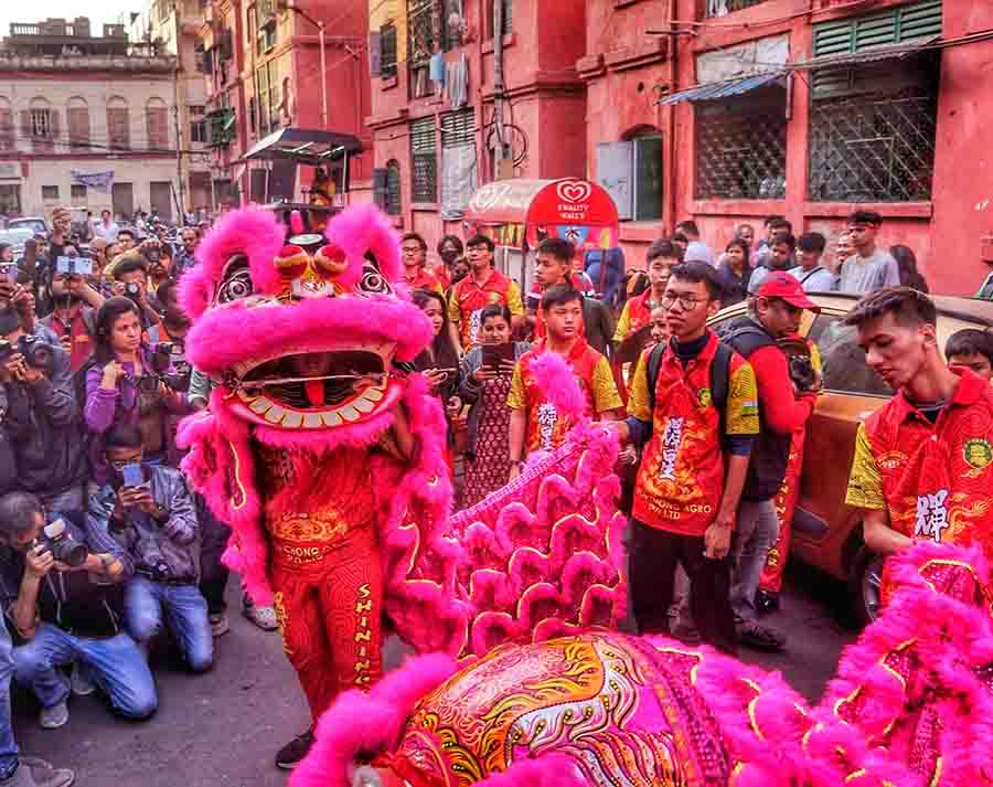 Clashing gongs and cymbals as part of the Dragon Dance is believed to chase away ghosts and evil spirits during the Chinese New Year celebrations 