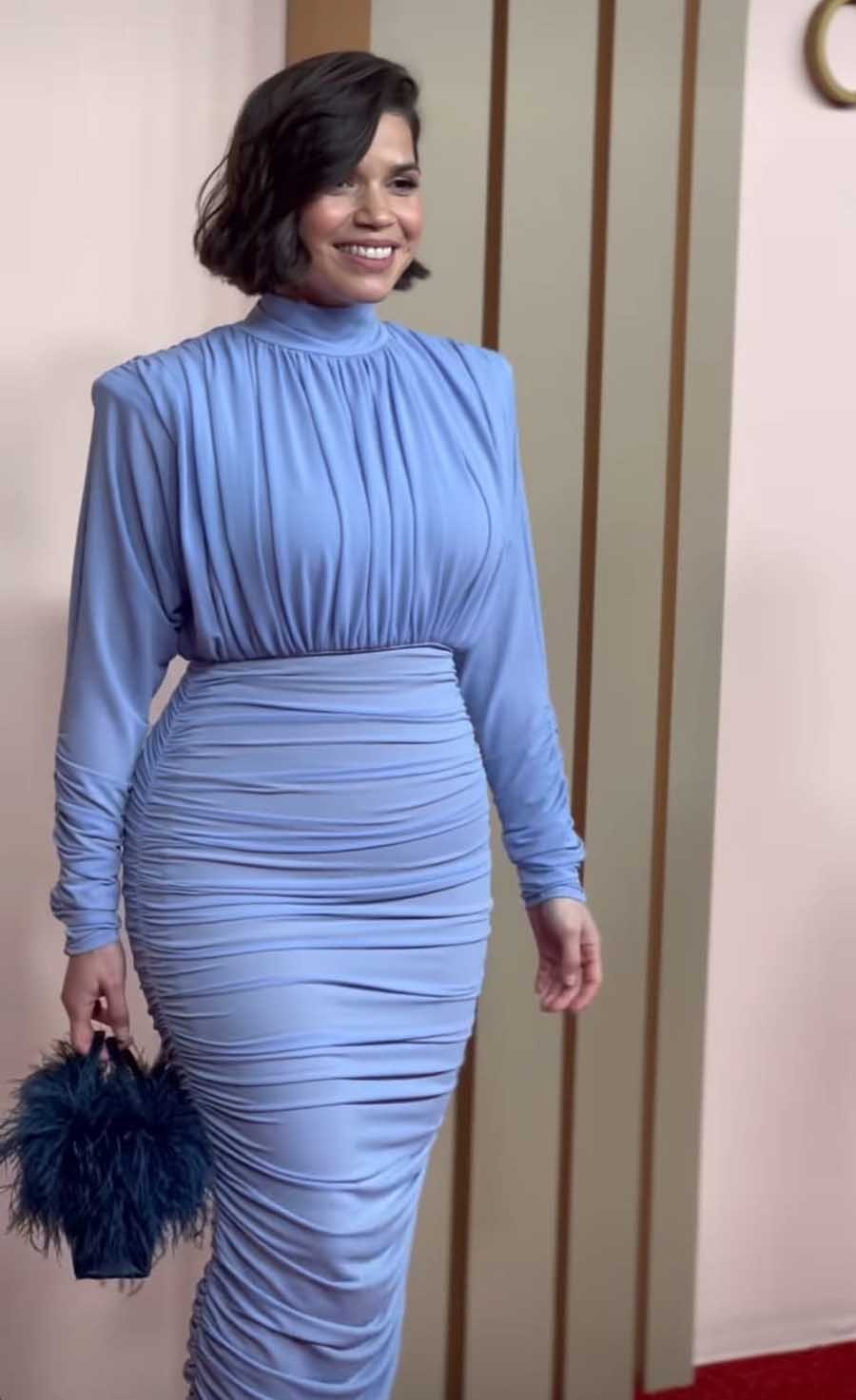 America Ferrera, recognised for her portrayal of Gloria in Gerwig’s Barbie, turned heads in a pale blue column gown. A handbag, embellished with darker-hued feathers, complemented her outfit. 