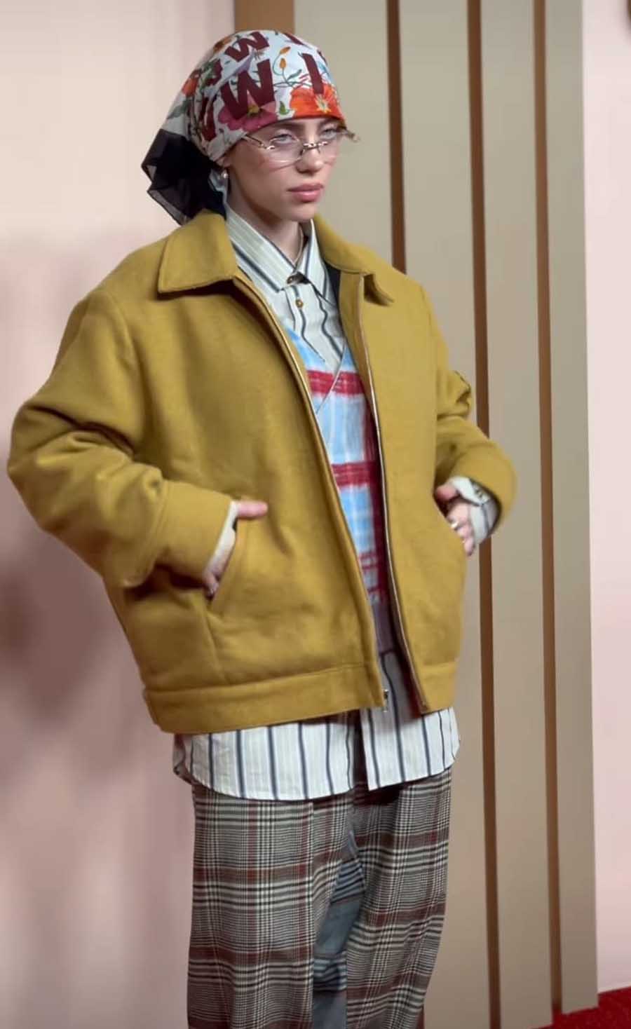 What Was I Made For singer rocked a mustard yellow jacket worn atop a striped shirt. Cap-toed Mary Jane shoes and a printed bandana completed her look for the event.