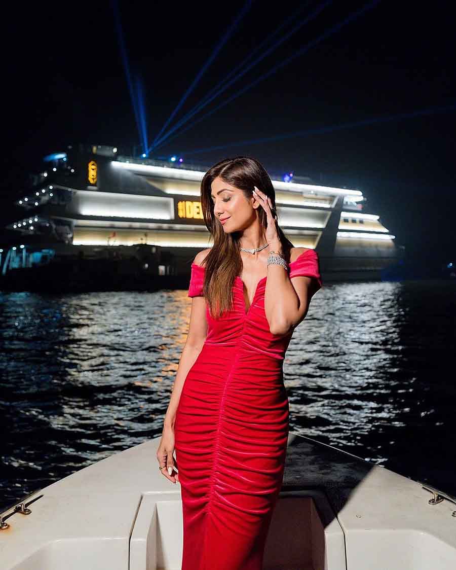 Shilpa Shetty Kundra looked glamorous in a red off shoulder ruched gown. Her sleek hair and diamond accessories made for a simple yet elegant look.