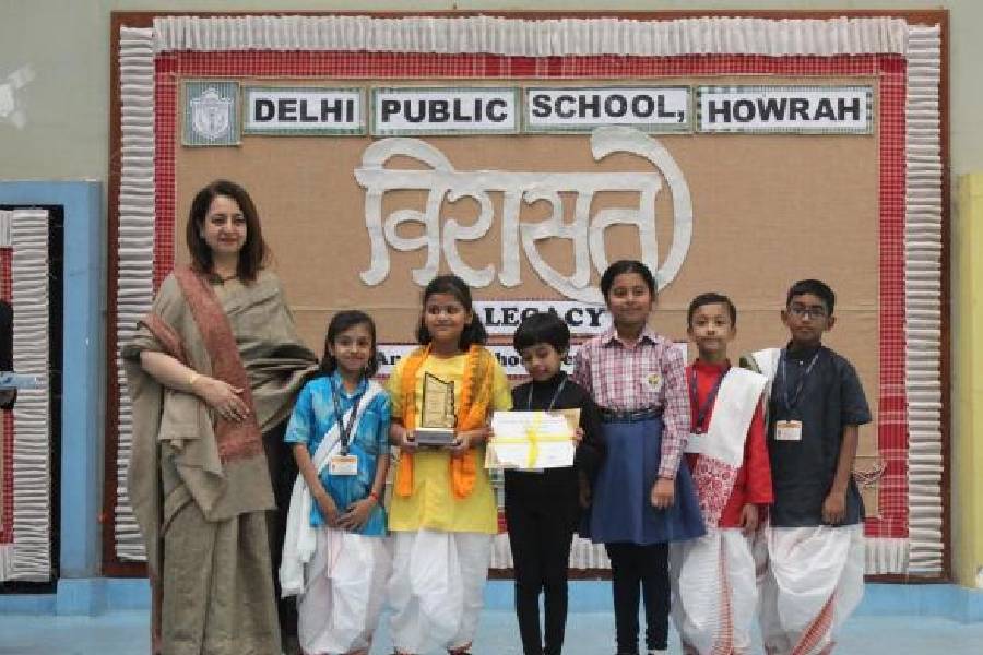 Principal Sunita Arora takes a picture with some prize winners