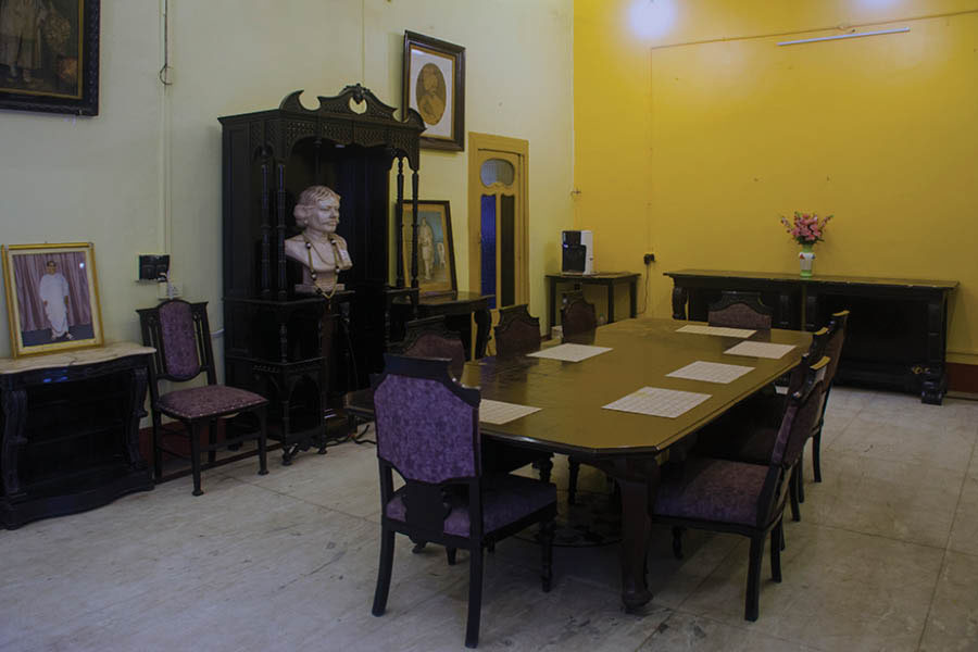 The dining room with a bust of Khelat Ghosh and portraits of members of Ghosh family
