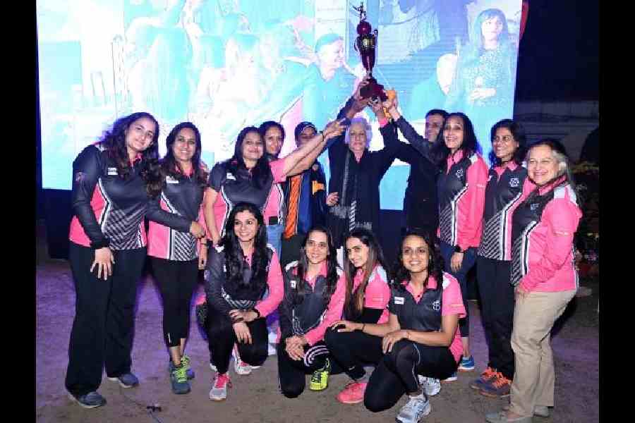 The winning team in the women's category, the Spice Girls, strike a pose for the camera, as they raise a toast to their success.