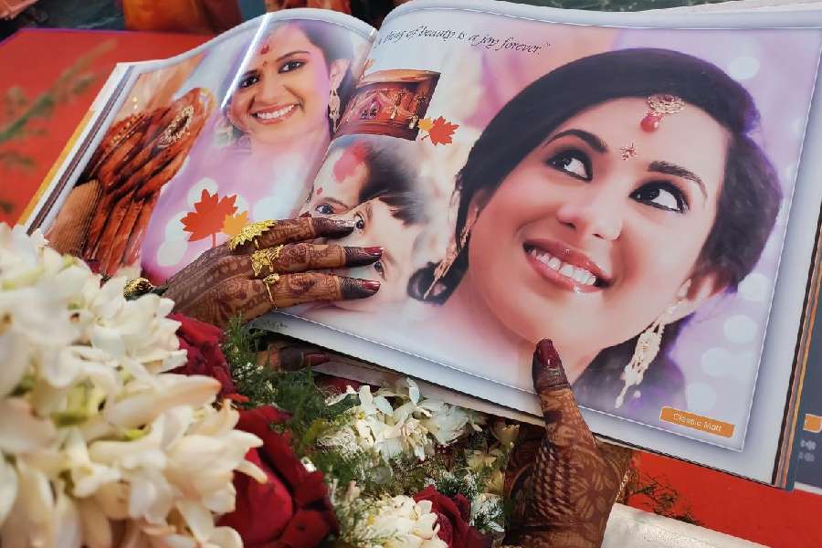 A bride turns the pages of the pre-wedding album