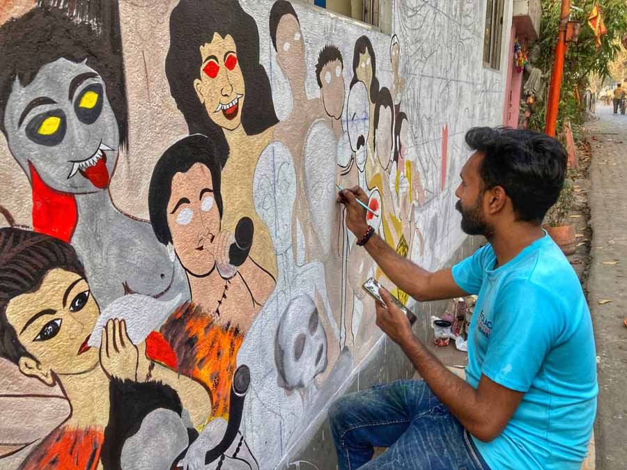 A man draws graffiti art on a wall at Bagbazar on Sunday, ahead of Shivratri, which falls on March 8 this year   