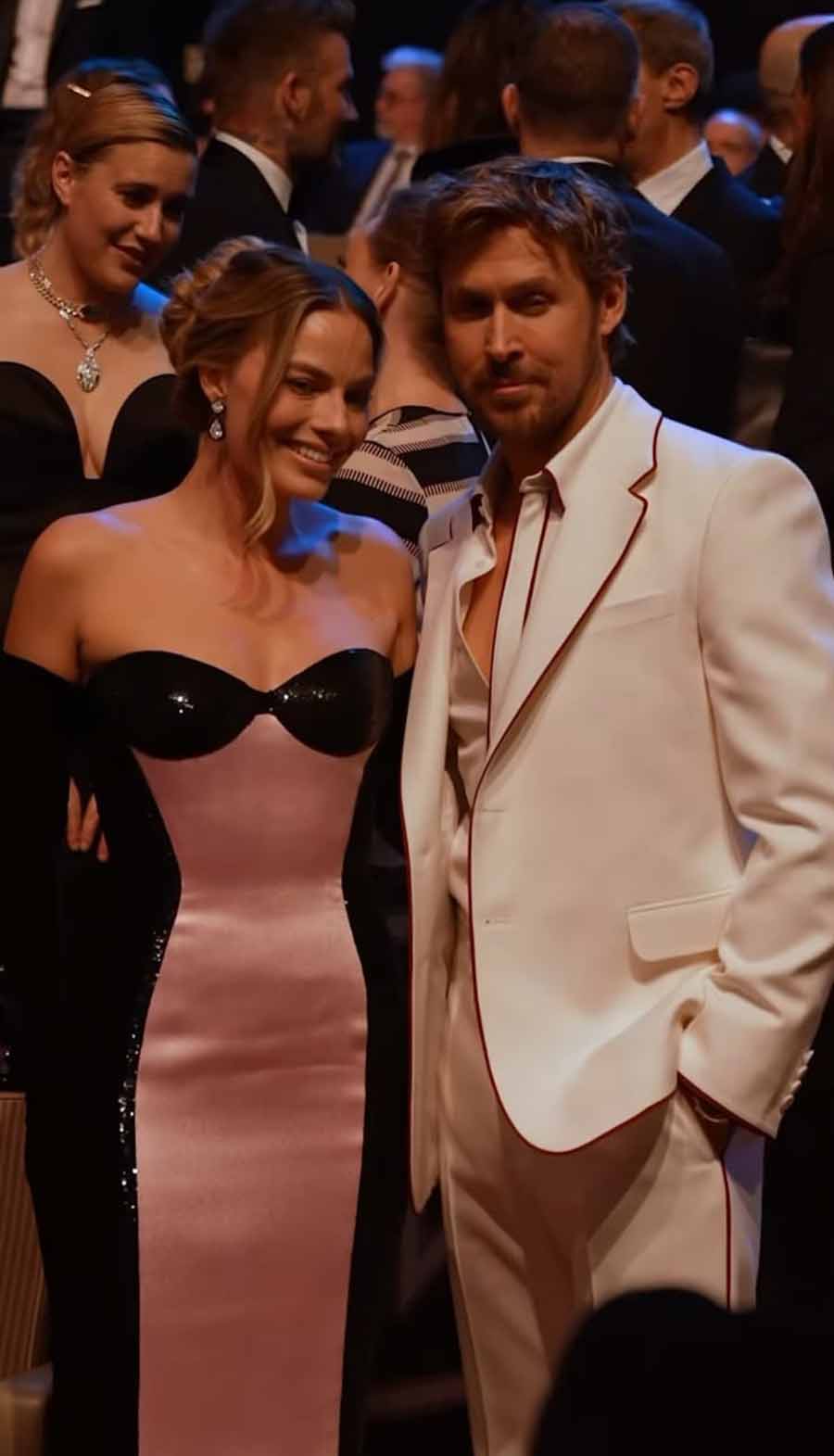 Ryan Gosling posed with his co-star Robbie in a sharp white suit.  