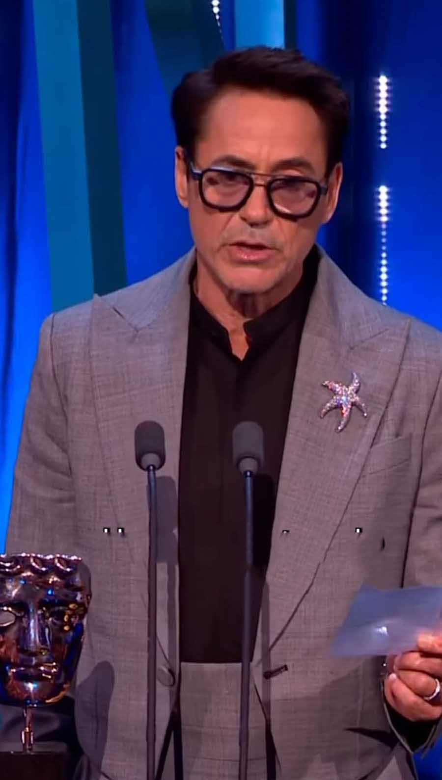 Robert Downey Jr., who won the Best Supporting Actor award for playing Lewis Strauss in Oppenheimer, donned a grey checkered blazer with a sequined starfish brooch over a black shirt. 