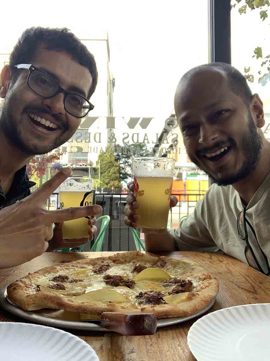 Sayak and I share a pizza with pulled pork and mango topping