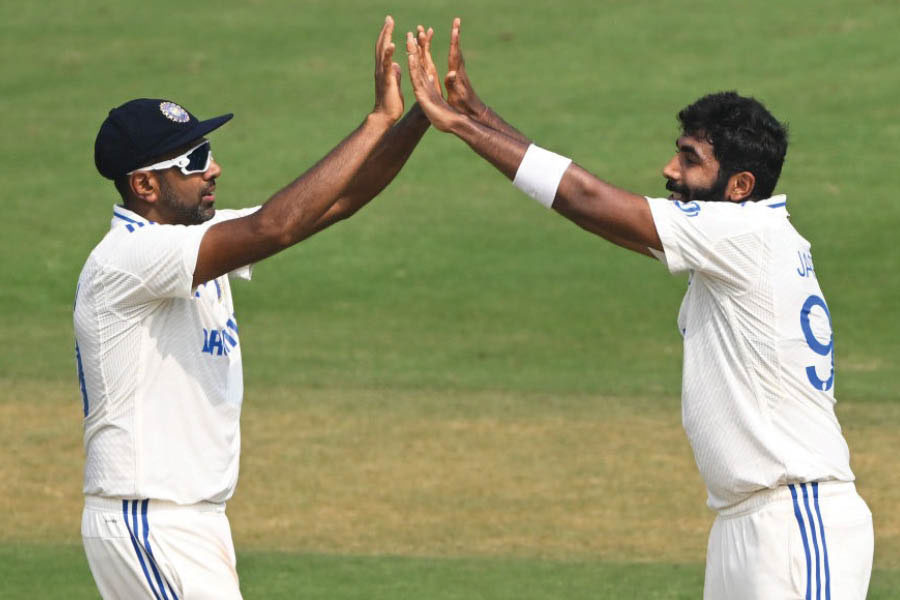 Jasprit Bumrah and (right) Ravichandran Ashwin celebrate the dismissal of Joe Root on day two of the 2nd Test between India and England in Visakhapatnam’s ACA-VDCA Stadium 