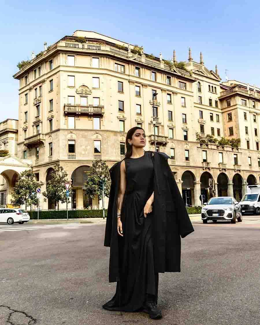Rashmika turned heads at the fashion show in a black gown paired with a cape blazer featuring pleats at the waist and an asymmetric hemline.