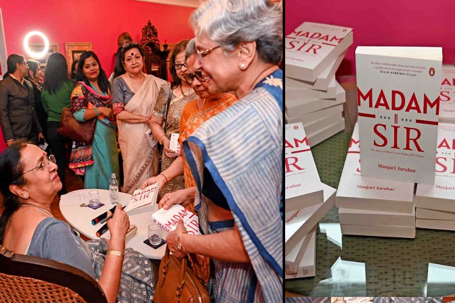 Manjari Jaruhar signs books for her guests, and (right) copies of Madam Sir, published by Penguin Random House India, on display at the Glenburn Penthouse