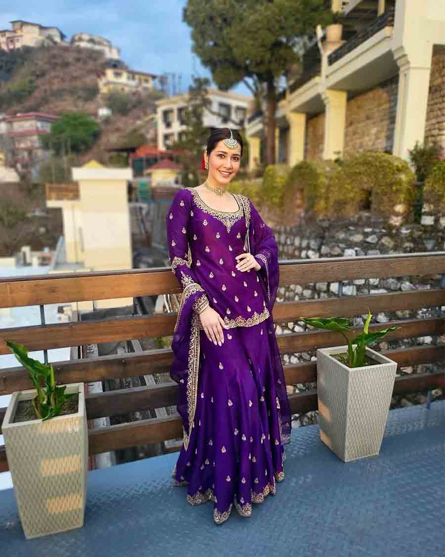 Raashii exudes grace in a purple garara set featuring intricate gold embroidery at the border and the neckline. She paired the ensemble with a matching choker, statement earrings and a mangtika. 