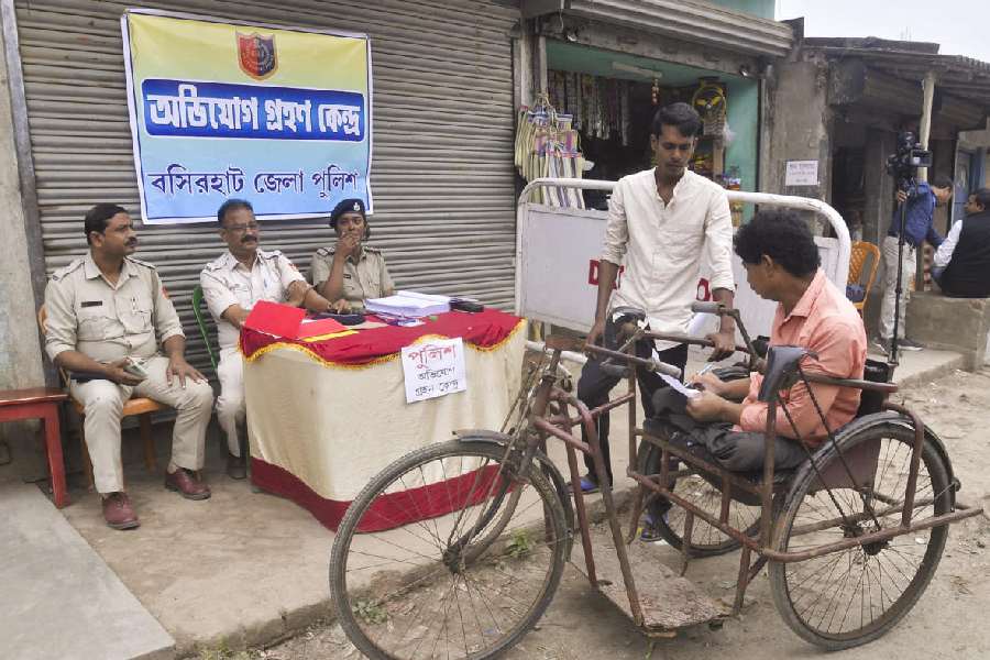 Police personnel interact with villagers at Sandeshkhali, in North 24 Parganas district