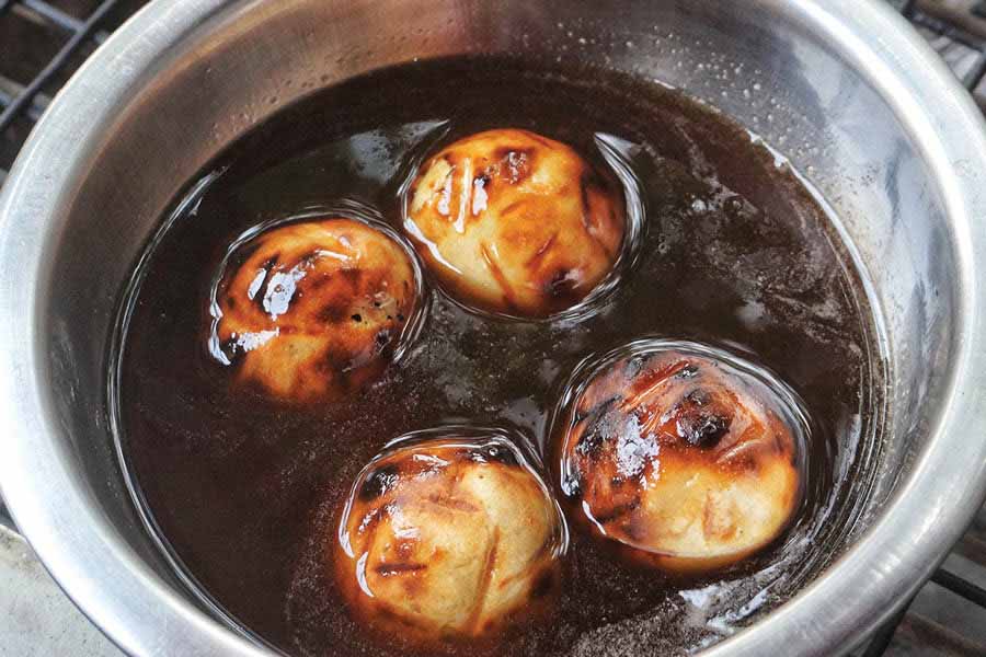 After roasting on a charcoal grill, the littis are are given a generous dunking in desi ghee