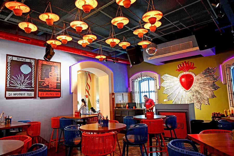 The lively interiors of Mehico with sombrero lanterns, wicker chairs and a large Mexican sacred heart