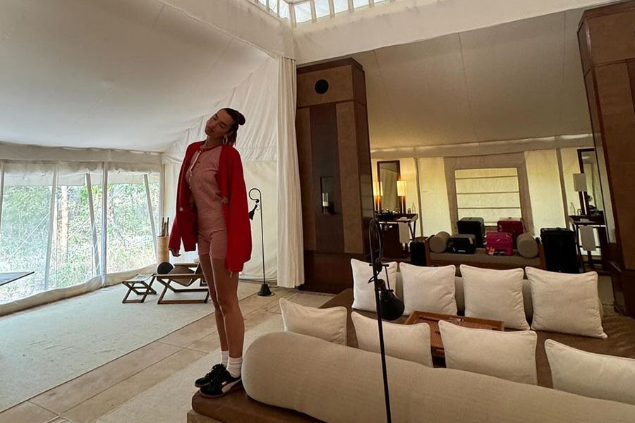 The Physical singer went for a casual look in a red-and-white striped onesie paired with a solid red shrug.