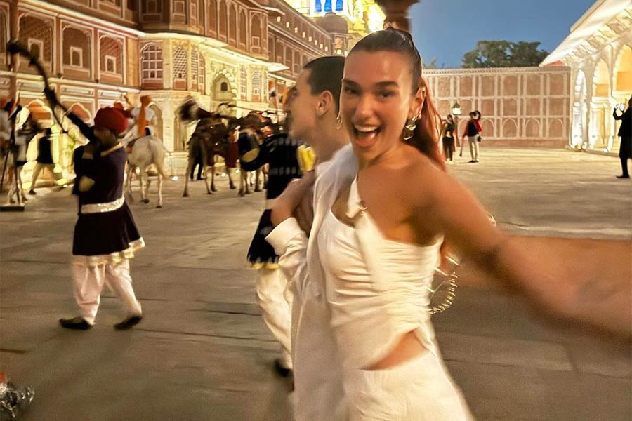 Dua enjoyed herself at a palace with her brother. The three-time Grammy winner sported a pleated tube top paired with a matching mini skirt and a cross sling.