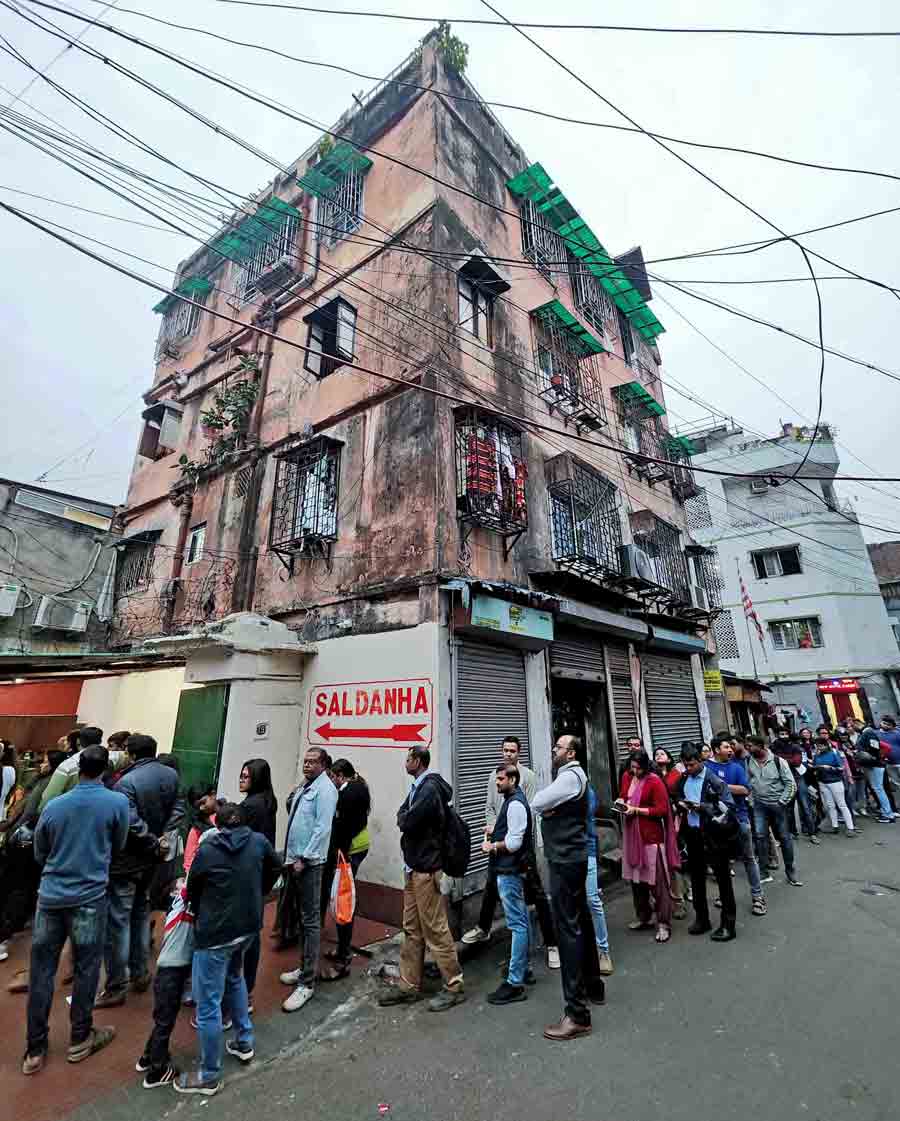 A winding queue formed outside the almost century-old Saldanha Bakery in Kolkata, extending beyond its building off Rafi Ahmed Kidwai Road, on the evening of December 23