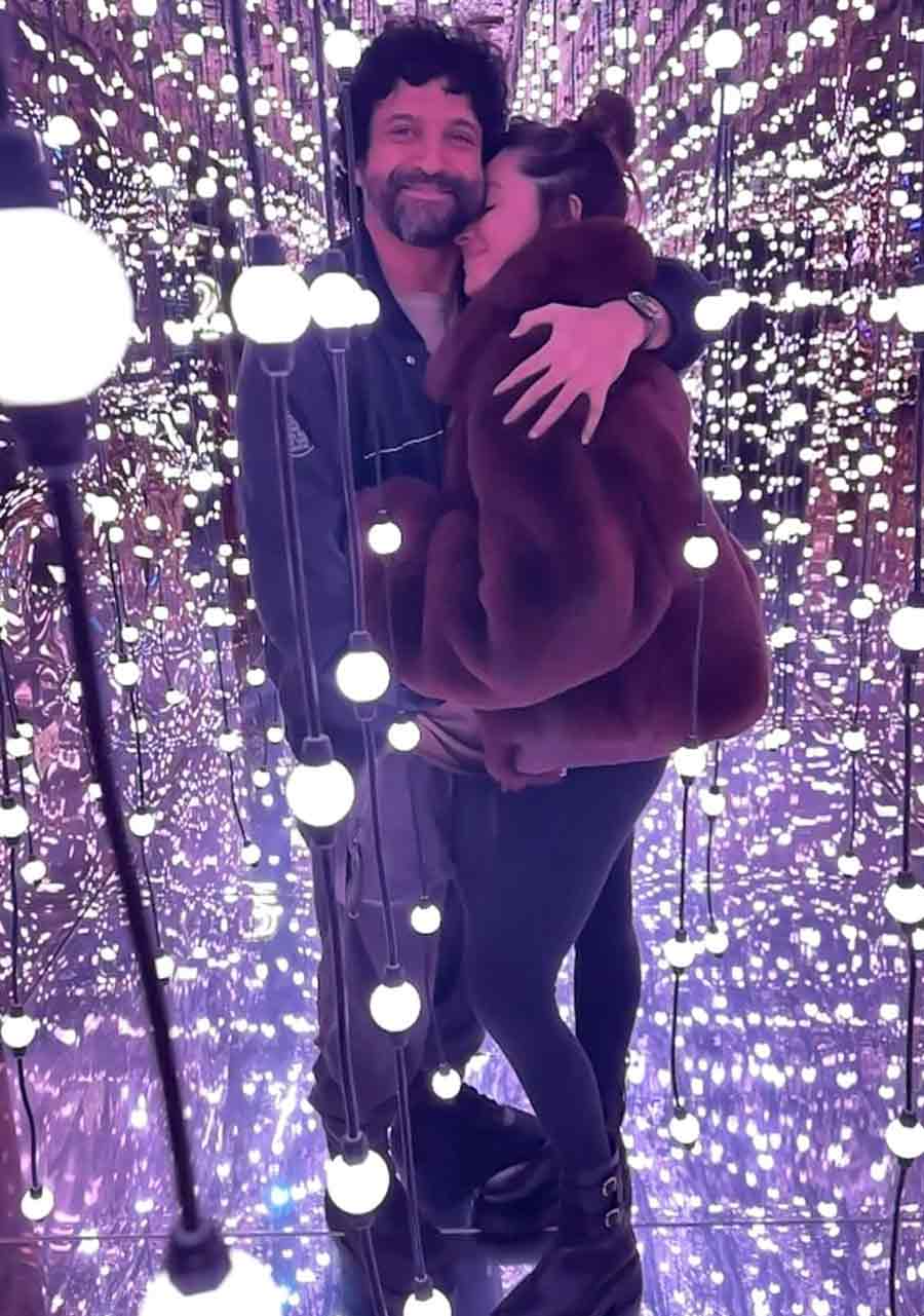 Farhan Akhtar embraced wife Shibani against a backdrop of lights.
