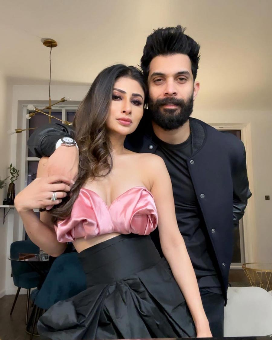 Mouni Roy, looking gorgeous in a mauve tube top and a black skirt, posed for a photograph with husband Suraj Nambiar.  