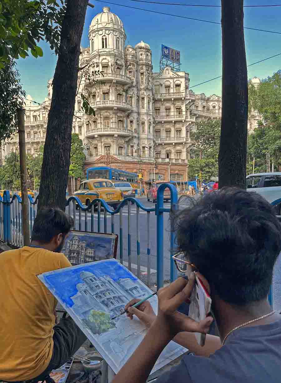 Artists painting the heritage Esplanade Mansion in Kolkata on Wednesday  