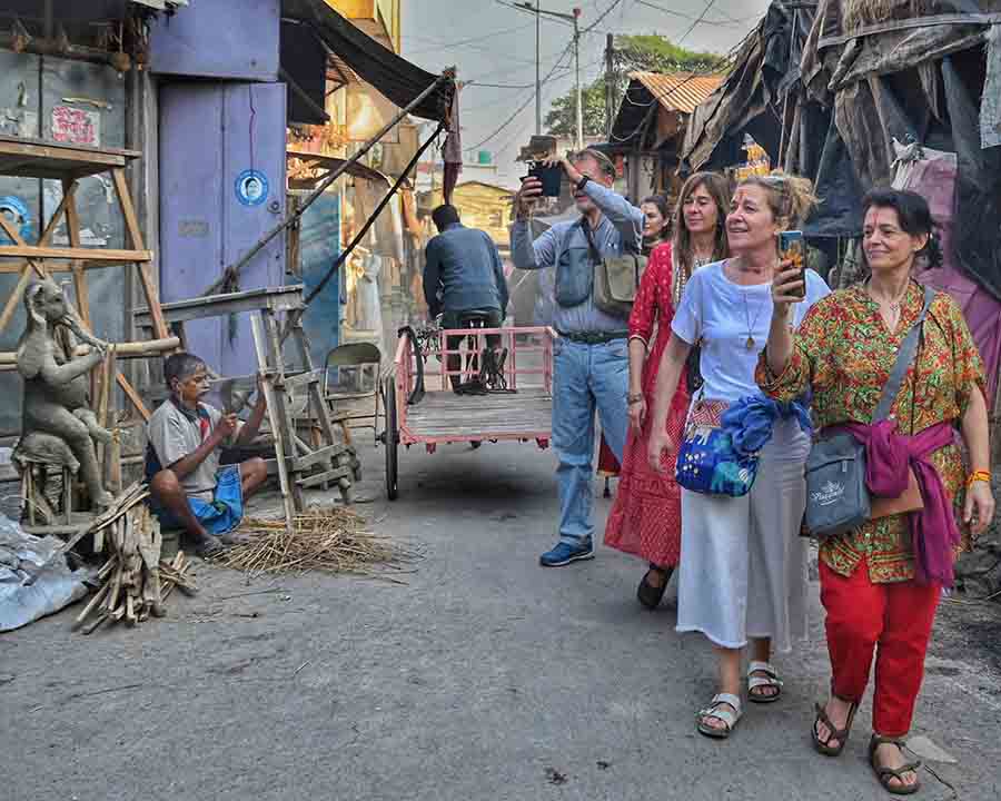 Foreign tourists take a stroll at Kumartuli on Wednesday  