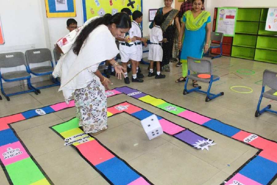 Parents check out a version of ludo at the Math Mela 2023.