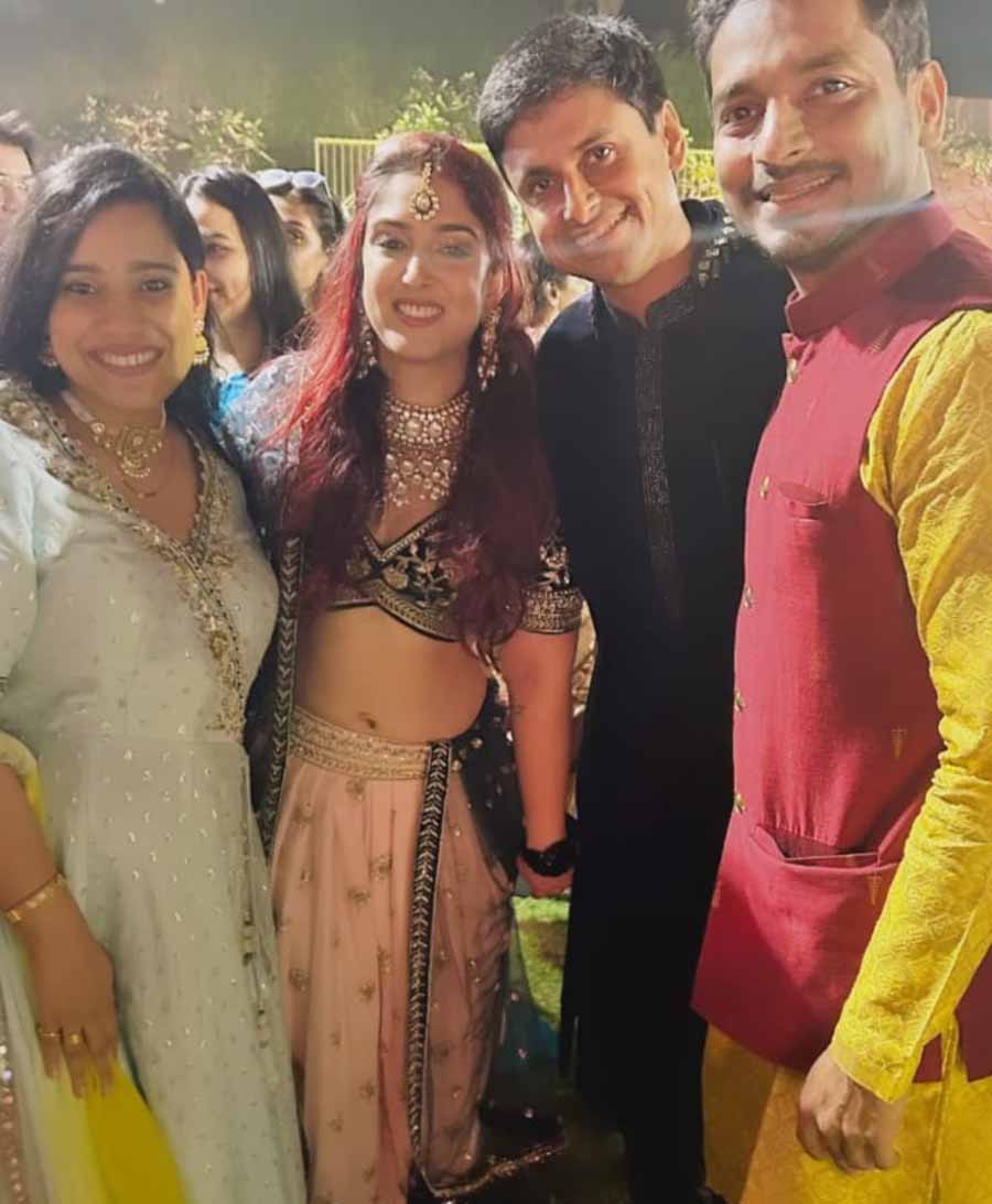 The newlyweds posed for a picture with their friends after the ceremony.  