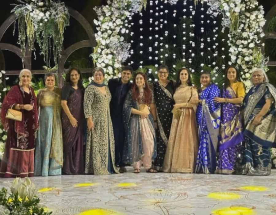 Ira and Nupur posed for a family picture against a floral backdrop. 